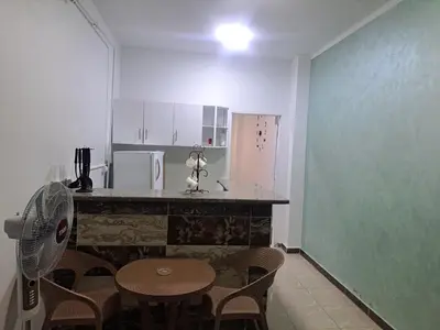 a kitchen with a table and chairs and a refrigerator at Sweet Home- ممنوع للمصريين Open 24 Hour in Hurghada