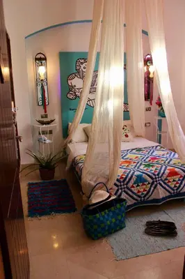 a bedroom with a bed with a mosquito net at Beit Matta in Hurghada