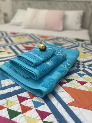 a stack of blue towels sitting on a bed at Beit Matta in Hurghada
