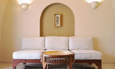 a living room with a couch and a table at Malkata House - Boutique hotel and restaurant in Luxor