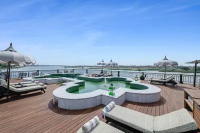 a deck with a swimming pool on a pier at Movenpick SS Misr Steamer Nile Cruise - 04 & 07 Nights Each Monday From Luxor and 03 Nights Each Friday from Aswan in Luxor