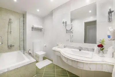 a bathroom with a sink and a tub and a toilet at Tolip Aswan Hotel in Aswan