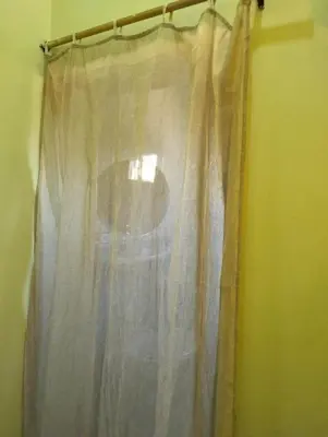 a curtain on a curtain rod in a room at Roma Guest house in Aswan
