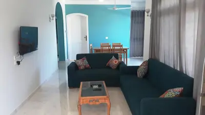 a living room with two blue couches and a coffee table at New Modern Flats in Luxor