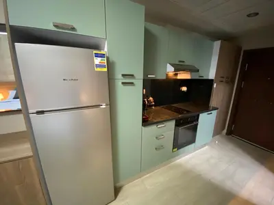 a kitchen with a refrigerator and a stove at Awesome Pool View Studio in Al Dau Heights in Hurghada