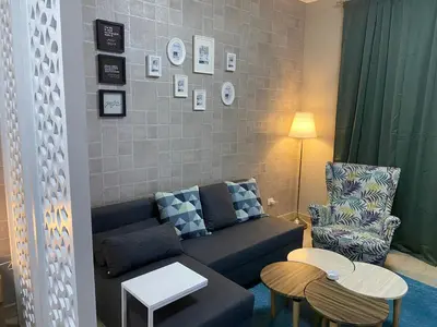 a living room with a couch and a chair at Awesome Pool View Studio in Al Dau Heights in Hurghada