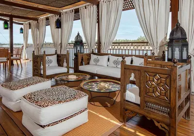 a living room with couches and a table at Dahabeya Yakouta Nile Cruise-Every Monday from Luxor- Aswan for 05 nights in Luxor