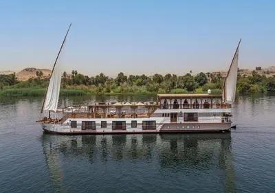 a large boat on the water with its sails at Dahabeya Yakouta Nile Cruise-Every Monday from Luxor- Aswan for 05 nights in Luxor
