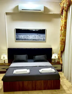 a bedroom with a bed with two towels on it at Karnak Flats in Luxor