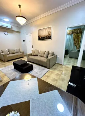 a living room with two couches and a table at Karnak Flats in Luxor