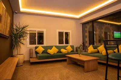 a living room with a green couch with yellow pillows at Al Dora Boutique Hotel in Hurghada