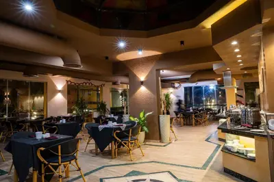 a restaurant with tables and chairs in a room at Al Dora Boutique Hotel in Hurghada
