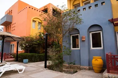 a blue building with a large yellow vase in front of it at Al Dora Boutique Hotel in Hurghada
