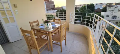 a balcony with a table and chairs on a balcony at Senmut Luxory Apartments in Luxor