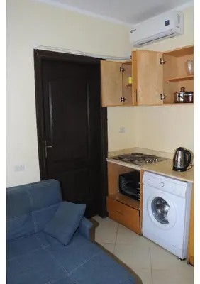 a kitchen with a washing machine and a washer at Apartments in Florenza Khamsin in Hurghada