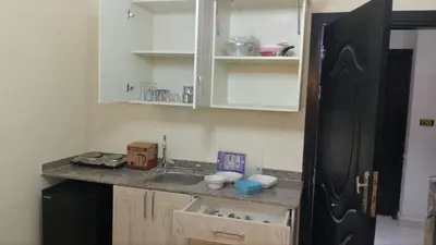 a kitchen with a sink and a black refrigerator at Studio H in Florenza Khamsin in Hurghada