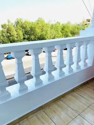 a white railing on a balcony with a street at Solider Dali in Hurghada