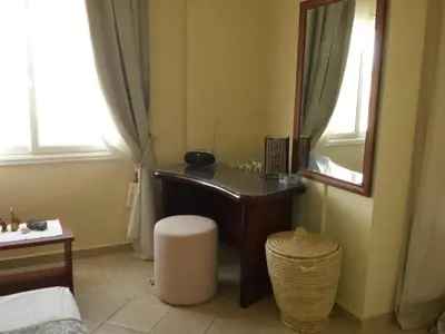 a bedroom with a desk and a mirror in a room at Beachfront Cozy One Bedroom apartment Sahl Hasheesh Palma de Piazza in Hurghada