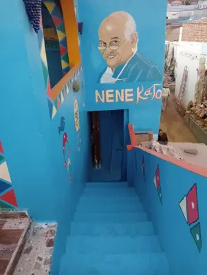 a blue staircase with a sign that reads neere kyi at NeNeKaTo Nubian House in Aswan