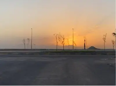 an empty parking lot with a sunset in the background at Bahga Palace 4 Residential Apartments in Hurghada