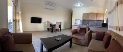 a living room with a couch and a table at Bahga Palace 4 Residential Apartments in Hurghada