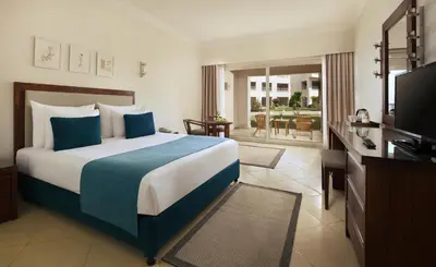 a hotel room with a bed and a television at JAZ Soma Beach in Hurghada
