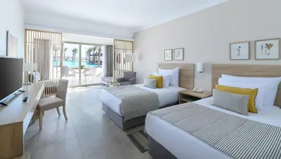 a hotel room with two beds and a desk at JAZ Costa Mares- Adults Friendly 16 Years Plus in Marsa Alam City