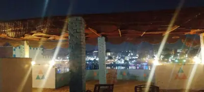 a stage with a view of a city at night at Winji Guest house in Aswan