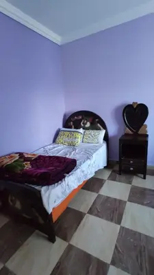 a bedroom with a bed and a checkered floor at IKEA Flats in Hurghada