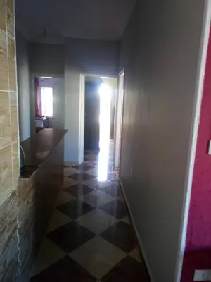 a hallway with a door and a tile floor at IKEA Flats in Hurghada