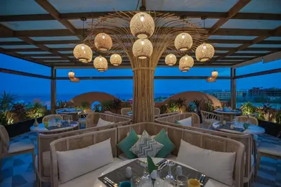 a rendering of a restaurant with tables and chandeliers at AJIRA Boutique Hotel Hurghada Marina in Hurghada