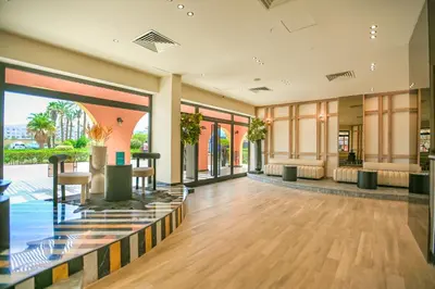 an empty lobby with tables and chairs and windows at AJIRA Boutique Hotel Hurghada Marina in Hurghada
