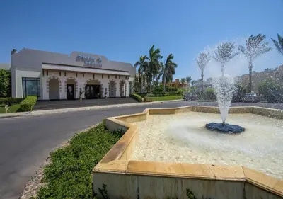 a fountain in the middle of a street in front of a building at Chalet at Stella Makadi Beach in Hurghada