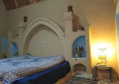 a bedroom with a bed with an arch above it at Scorpion House Luxor in Luxor