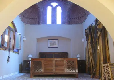 an archway in a church with a bed and windows at Scorpion House Luxor in Luxor