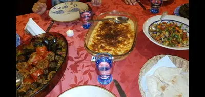 a table topped with a table topped with dishes of food at Scorpion House Luxor in Luxor