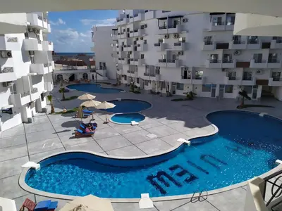 an overhead view of a swimming pool in front of a building at Studio beside El Gouna with good kite spot in 500 m in Hurghada