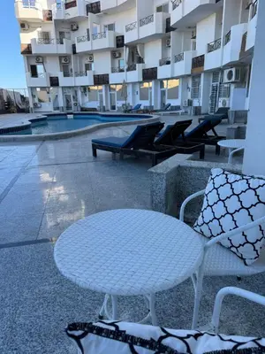 a white table and chairs in front of a building at Studio beside El Gouna with good kite spot in 500 m in Hurghada