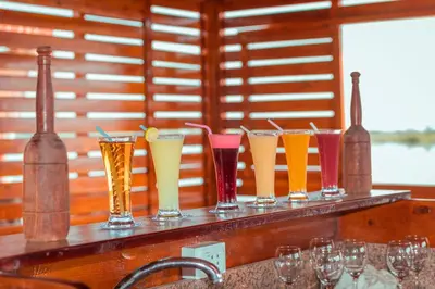a row of different colored glasses on a counter at Dahabiya ECO Queen Cleopatra in Esna