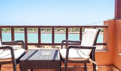 a table and chairs on a balcony with a view at El Gouna 1 bedroom apartment in West Golf Y12 in Hurghada