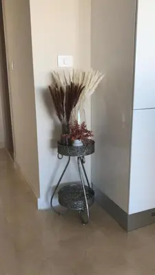 a table with plants on it next to a refrigerator at Jutta Deluxe 2-Bedroom-Apartment Mangroovy-M7 El Gouna in Hurghada