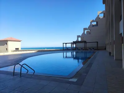 a swimming pool in the middle of a building at Full Apartment with Panoramic View of Hurghada in Hurghada