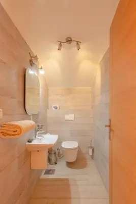 a bathroom with a sink and a toilet and a mirror at 4 Bedroom Villa with Heated Pool, Jacuzzi & Lagoon View in Phase 4 in Hurghada