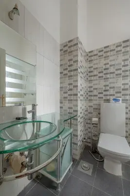 a bathroom with a glass sink and a toilet at 4 Bedroom Villa with Heated Pool, Jacuzzi & Lagoon View in Phase 4 in Hurghada