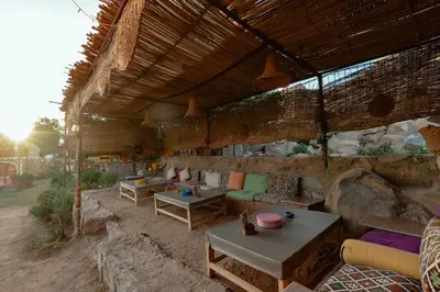a large outdoor room with couches and tables at Krouma Camp & Ecolodge in Aswan