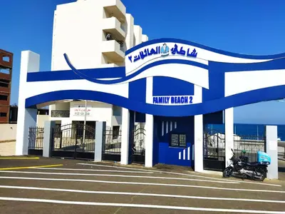 a blue and white building with a motorcycle parked in front at apartment with separate entrance near Arabia hotel in Hurghada