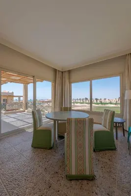 a room with a table and chairs and windows at VESTA - Soma Bay Residence in Hurghada
