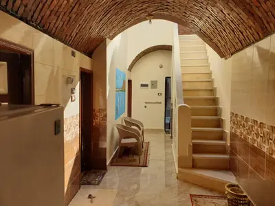 a hallway with a stairway in a building with a stair case at Dara guest House in Aswan