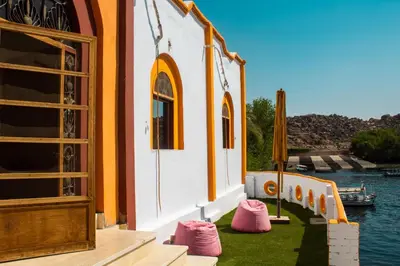 a building with pink stepping stones on the grass at Wanas Kato Guest House in Shellal