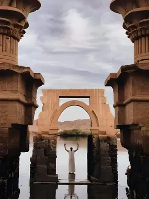 a man standing in water in front of an arch at Wanas Kato Guest House in Shellal